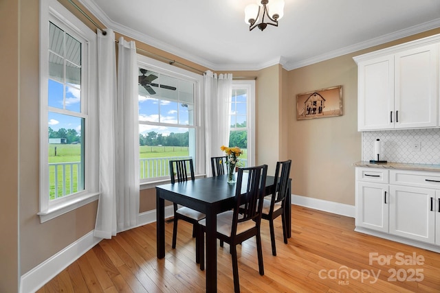3707 Seagrave Farm Rd, Concord, NC 28025 - dining room with baseboards, light wood-style flooring, ornamental molding, and a chandelier