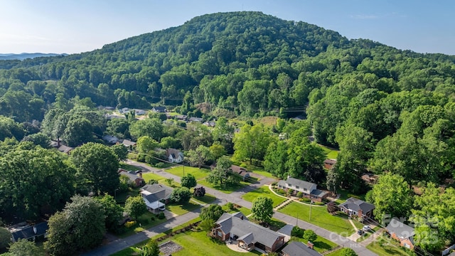 aerial view of property's location featuring a forest