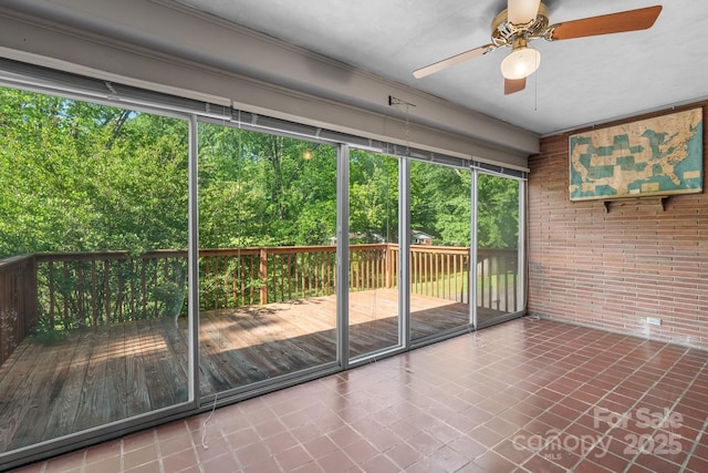 unfurnished sunroom with a ceiling fan