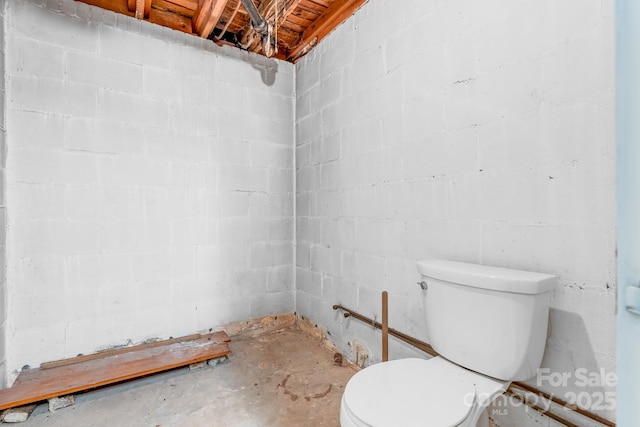 bathroom featuring concrete floors and toilet