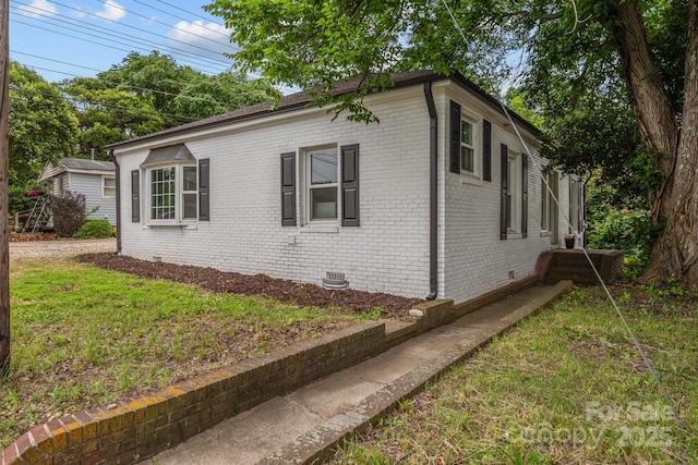 207 Eden St, Davidson, NC 28036 - view of property exterior featuring crawl space, brick siding, and a lawn