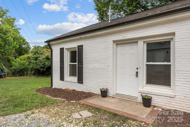 207 Eden St, Davidson, NC 28036 - entrance to property with brick siding, a lawn, and roof with shingles