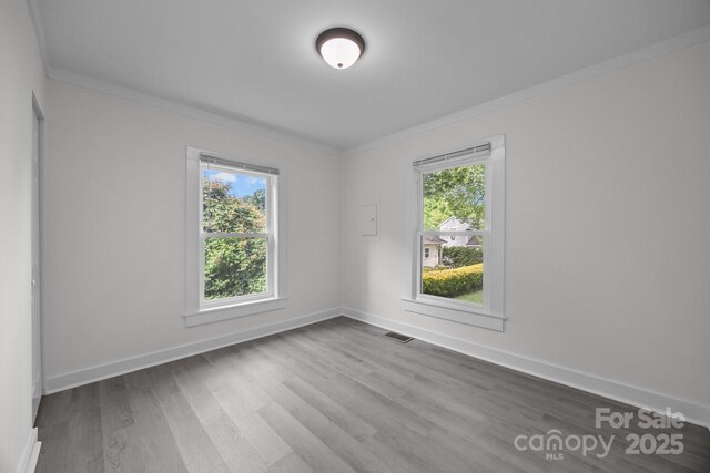 207 Eden St, Davidson, NC 28036 - spare room with ornamental molding, wood finished floors, and baseboards