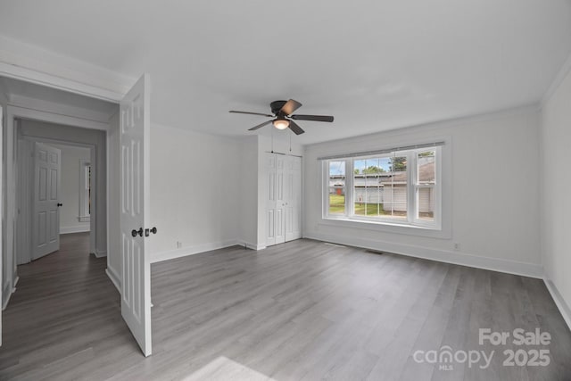 207 Eden St, Davidson, NC 28036 - unfurnished living room featuring a ceiling fan, wood finished floors, and baseboards