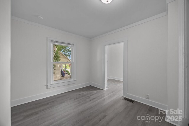 207 Eden St, Davidson, NC 28036 - spare room with crown molding, dark wood-style floors, baseboards, and a smoke detector