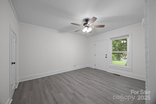 207 Eden St, Davidson, NC 28036 - unfurnished room with crown molding, dark wood-style floors, a ceiling fan, and baseboards