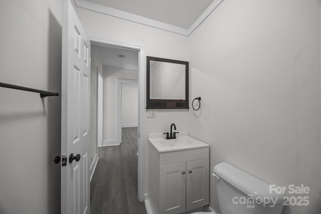 207 Eden St, Davidson, NC 28036 - half bathroom featuring toilet, vanity, baseboards, and wood finished floors
