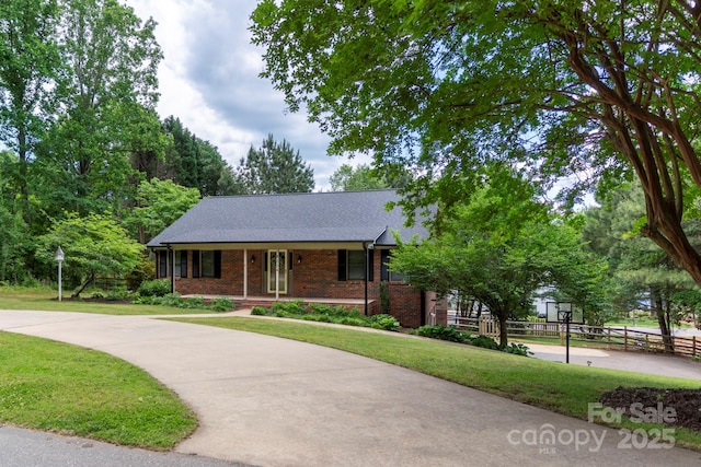 8024 Bradford Ln, Denver, NC 28037 - view of front facade featuring brick siding, a shingled roof, and covered porch