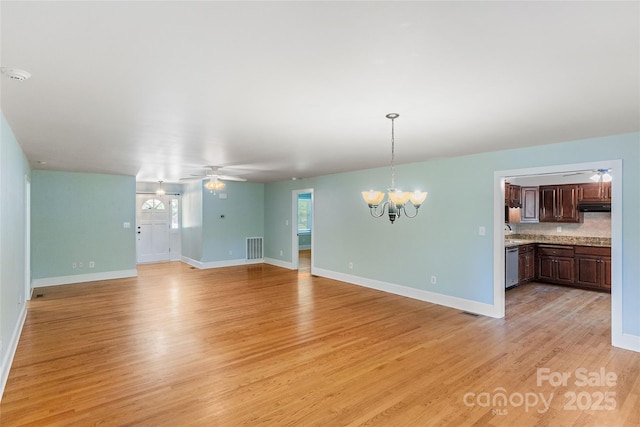 8024 Bradford Ln, Denver, NC 28037 - unfurnished living room with a chandelier, light wood finished floors, a ceiling fan, and baseboards