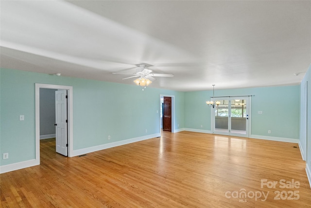 8024 Bradford Ln, Denver, NC 28037 - unfurnished room with a chandelier, light wood-style flooring, a ceiling fan, and baseboards
