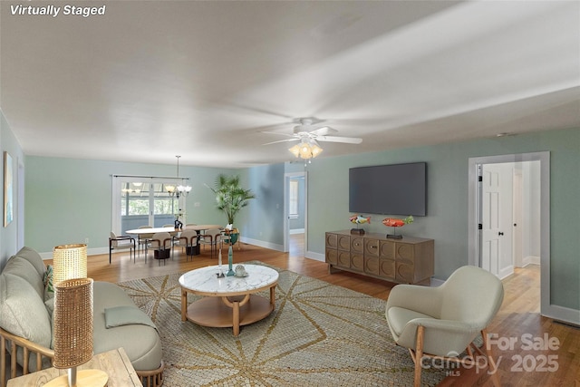 8024 Bradford Ln, Denver, NC 28037 - living area featuring a chandelier, wood finished floors, baseboards, and ceiling fan