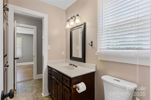8024 Bradford Ln, Denver, NC 28037 - bathroom featuring vanity, healthy amount of natural light, toilet, and baseboards