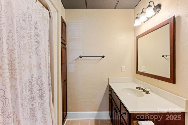 8024 Bradford Ln, Denver, NC 28037 - bathroom featuring vanity, tile patterned floors, baseboards, curtained shower, and a drop ceiling
