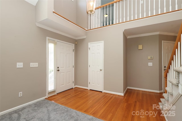 9315 Pebble Creek Way, Charlotte, NC 28269 - entrance foyer with a high ceiling, stairway, baseboards, wood finished floors, and ornamental molding