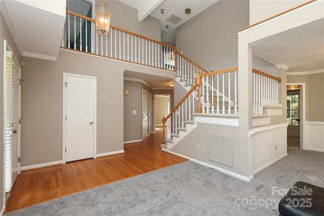 9315 Pebble Creek Way, Charlotte, NC 28269 - stairway with carpet, ornamental molding, wood finished floors, baseboards, and a high ceiling