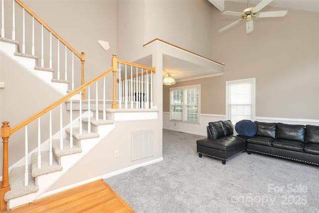 9315 Pebble Creek Way, Charlotte, NC 28269 - living room with high vaulted ceiling, stairs, ceiling fan, and carpet