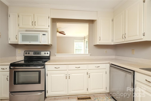 9315 Pebble Creek Way, Charlotte, NC 28269 - kitchen with appliances with stainless steel finishes, light countertops, white cabinetry, crown molding, and light tile patterned floors