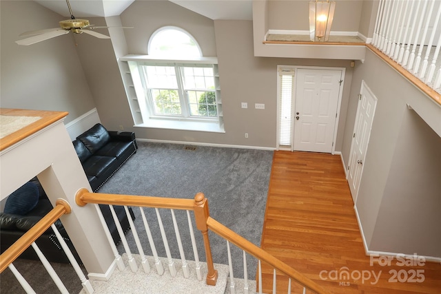 9315 Pebble Creek Way, Charlotte, NC 28269 - entryway featuring a ceiling fan, carpet, baseboards, a high ceiling, and wood finished floors