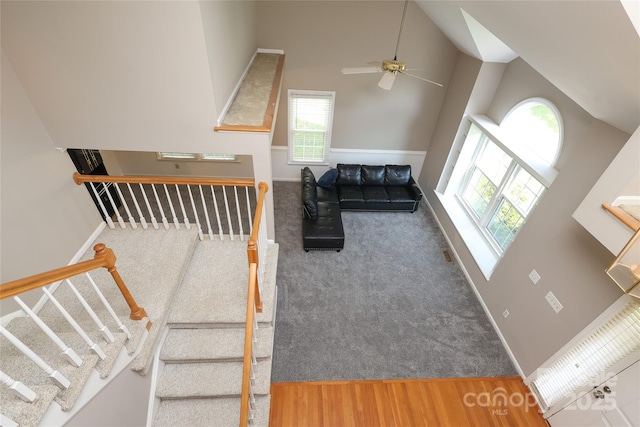 9315 Pebble Creek Way, Charlotte, NC 28269 - living area featuring high vaulted ceiling, healthy amount of natural light, ceiling fan, carpet, and stairway