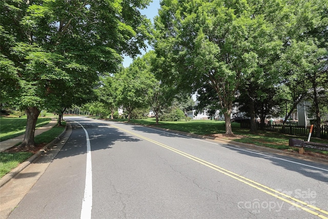 9315 Pebble Creek Way, Charlotte, NC 28269 - view of asphalt road with curbs and sidewalks