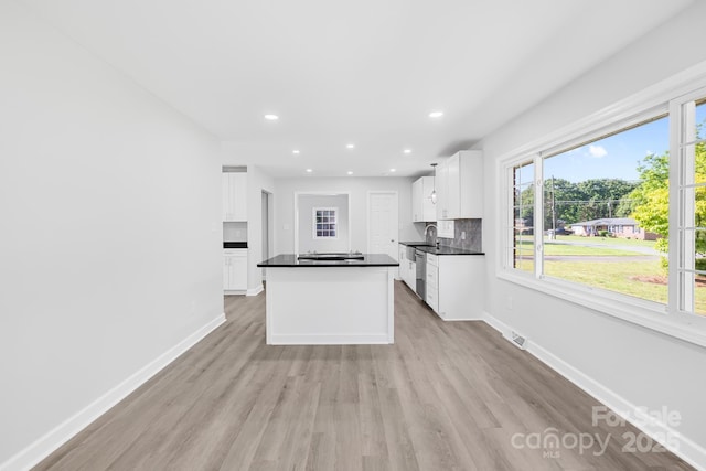 1408 Delview Rd, Cherryville, NC 28021 - kitchen featuring stainless steel dishwasher, dark countertops, light wood finished floors, white cabinetry, and recessed lighting