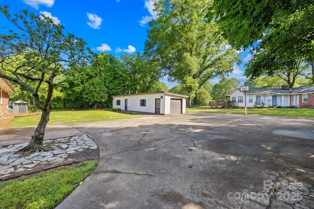 1408 Delview Rd, Cherryville, NC 28021 - view of front of home featuring an outdoor structure, asphalt driveway, a front yard, and a garage