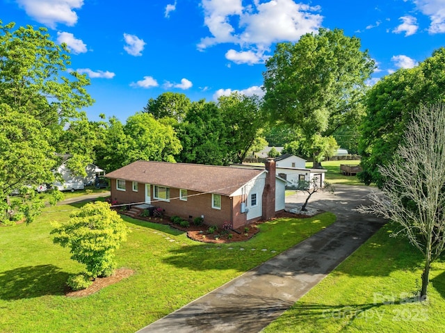 1408 Delview Rd, Cherryville, NC 28021 - view of property exterior featuring brick siding, a yard, asphalt driveway, and a chimney