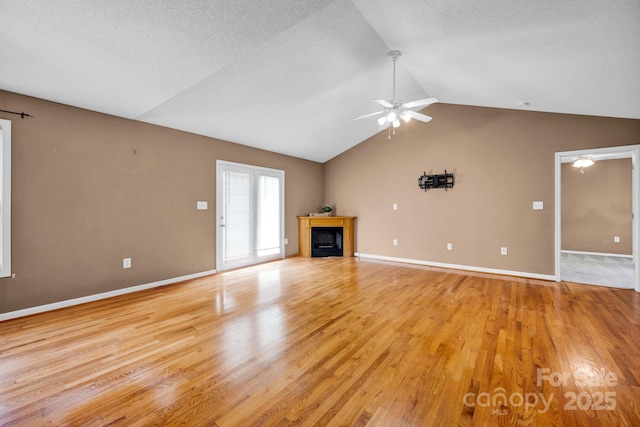 5678 Cedar Run Dr, Denver, NC 28037 - unfurnished living room featuring a fireplace, vaulted ceiling, light wood-style floors, a ceiling fan, and baseboards