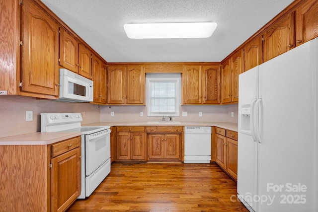 5678 Cedar Run Dr, Denver, NC 28037 - kitchen featuring white appliances, a sink, wood finished floors, brown cabinetry, and a textured ceiling
