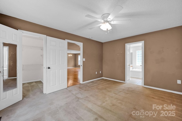 5678 Cedar Run Dr, Denver, NC 28037 - unfurnished bedroom featuring light colored carpet, a walk in closet, baseboards, ensuite bathroom, and a closet