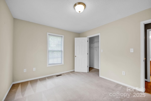 5678 Cedar Run Dr, Denver, NC 28037 - unfurnished bedroom featuring carpet, baseboards, a spacious closet, a closet, and a textured ceiling