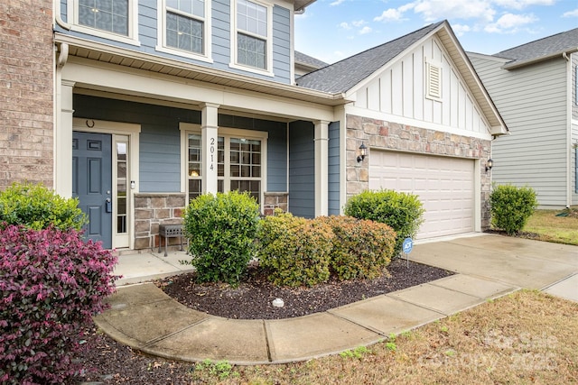 2014 Drawbridge Dr, Fort Mill, SC 29707 - view of front of house featuring covered porch, board and batten siding, stone siding, a garage, and driveway