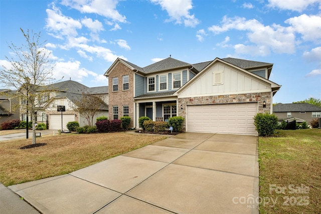 2014 Drawbridge Dr, Fort Mill, SC 29707 - view of front of home featuring board and batten siding, a front lawn, concrete driveway, a garage, and stone siding