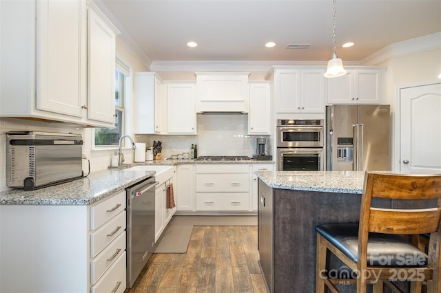 2014 Drawbridge Dr, Fort Mill, SC 29707 - kitchen featuring stainless steel appliances, white cabinets, wood finished floors, crown molding, and backsplash