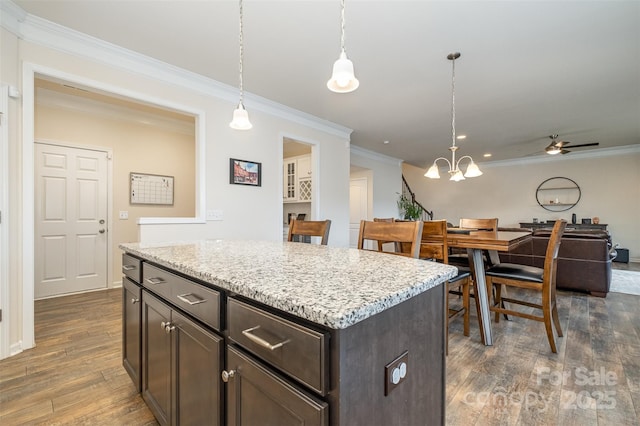 2014 Drawbridge Dr, Fort Mill, SC 29707 - kitchen with ornamental molding, dark wood finished floors, dark brown cabinetry, ceiling fan, and pendant lighting