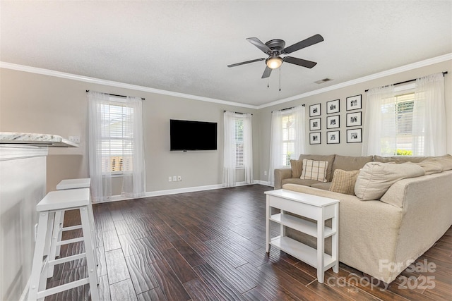 197 Devon Forest Dr, Mooresville, NC 28115 - living area featuring dark wood-type flooring, baseboards, ornamental molding, a ceiling fan, and healthy amount of natural light