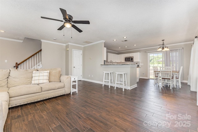 197 Devon Forest Dr, Mooresville, NC 28115 - living room with ceiling fan, recessed lighting, dark wood-style floors, a chandelier, and baseboards