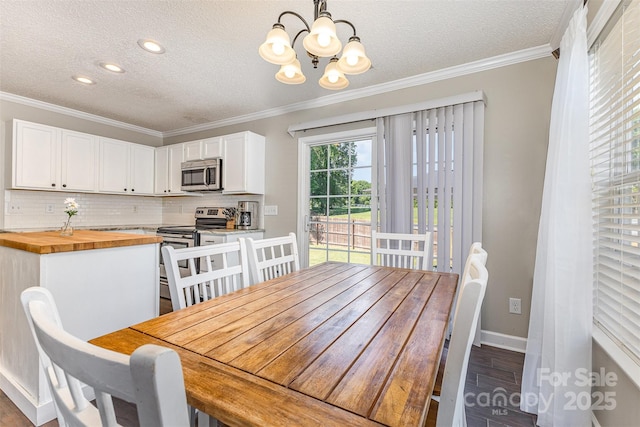 197 Devon Forest Dr, Mooresville, NC 28115 - dining space featuring a textured ceiling, a chandelier, dark wood finished floors, baseboards, and crown molding