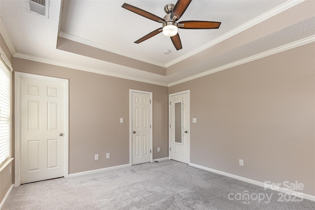 197 Devon Forest Dr, Mooresville, NC 28115 - unfurnished bedroom featuring light colored carpet, baseboards, a raised ceiling, ornamental molding, and a textured ceiling