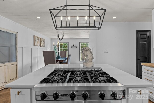 5229 Mt Holly Huntersville Rd, Charlotte, NC 28216 - kitchen featuring a chandelier, light countertops, stainless steel gas stovetop, white cabinets, and recessed lighting