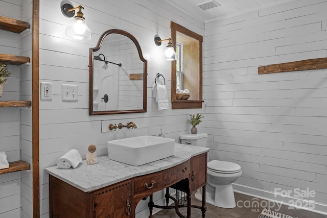 5229 Mt Holly Huntersville Rd, Charlotte, NC 28216 - full bathroom with a shower, toilet, vanity, and wooden walls