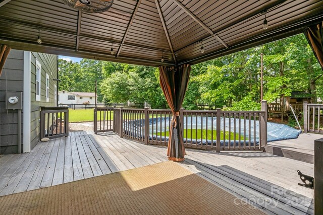 5229 Mt Holly Huntersville Rd, Charlotte, NC 28216 - deck with a fenced backyard, view of scattered trees, and a gazebo