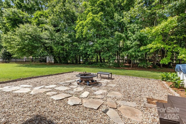 5229 Mt Holly Huntersville Rd, Charlotte, NC 28216 - view of patio featuring a fire pit and view of scattered trees