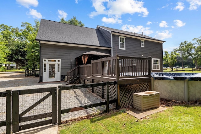 5229 Mt Holly Huntersville Rd, Charlotte, NC 28216 - rear view of house featuring a wooden deck and a covered pool
