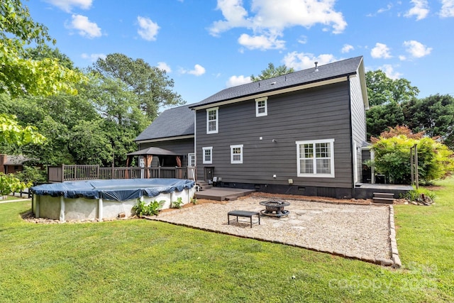 5229 Mt Holly Huntersville Rd, Charlotte, NC 28216 - back of house with a gazebo, a fire pit, a covered pool, and a lawn