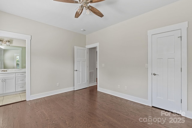 7 Lola Lilly Pl, Asheville, NC 28803 - unfurnished bedroom with wood finished floors, baseboards, ensuite bathroom, and a ceiling fan