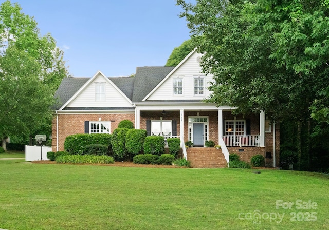 328 Whippoorwill Rd, Mooresville, NC 28117 - view of front of house featuring a front lawn, covered porch, and brick siding