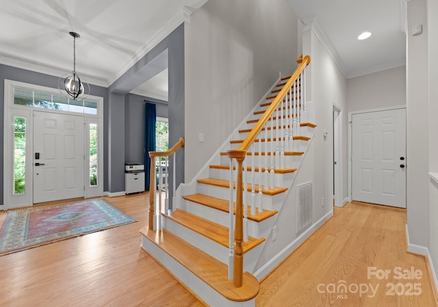 328 Whippoorwill Rd, Mooresville, NC 28117 - entryway with wood finished floors, stairway, ornamental molding, and baseboards