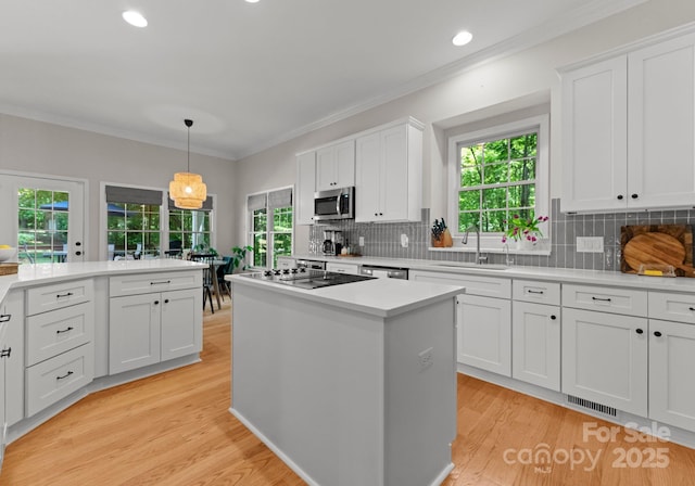 328 Whippoorwill Rd, Mooresville, NC 28117 - kitchen featuring a sink, appliances with stainless steel finishes, light countertops, white cabinetry, and decorative backsplash