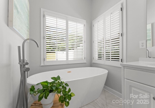 328 Whippoorwill Rd, Mooresville, NC 28117 - full bath with vanity, marble finish floors, a freestanding bath, and baseboards